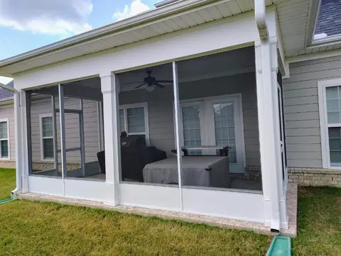 Finished white screened-in back porch