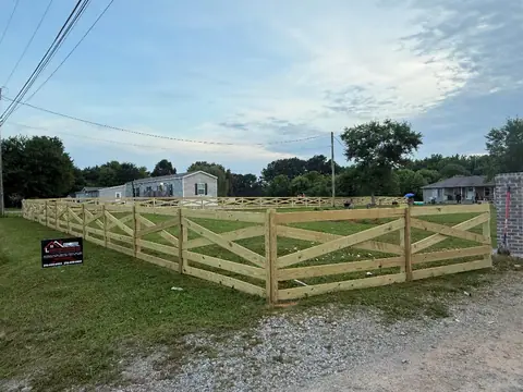 Wood crossbuck ranch fence at dusk